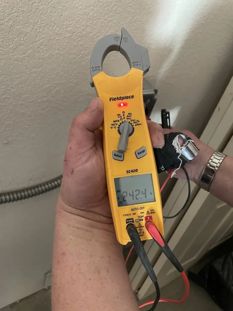 Voltage testing with clamp meter during Ceiling Fan Installation in Carthage